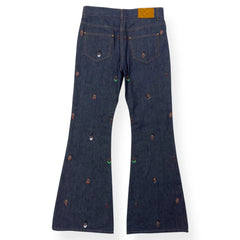 Dark blue jeans with decorative buttons on a white background