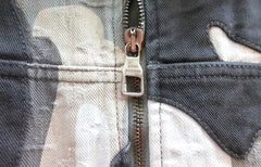 Close-up of a Louis Vuitton zipper on a denim jacket