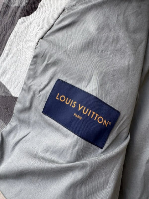 Louis Vuitton logo on a gray fabric background
