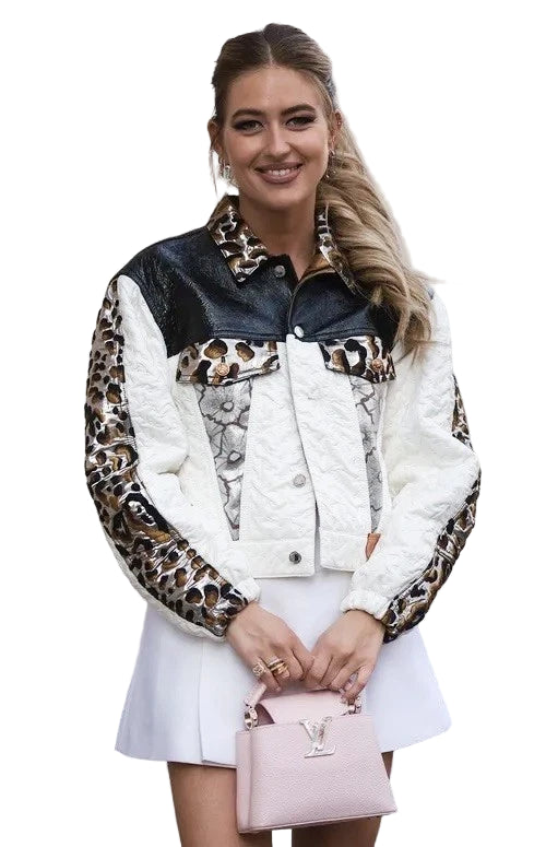 Woman wearing a leopard print and white jacket with a pink handbag.