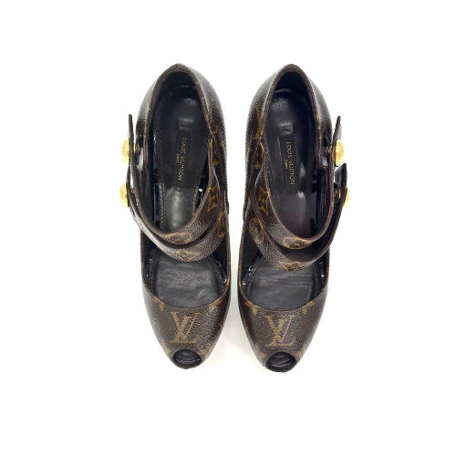 A pair of Louis Vuitton monogram pointed-toe pumps with open toes, ankle straps, and gold-tone buckle details, shown from a top-down view on a white background.