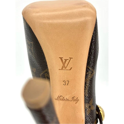 Close-up of the heel of a Louis Vuitton shoe in brown monogram canvas with a tan leather insole showing the embossed LV logo, size 37, and Made in Italy text.