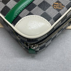Close-up of a Louis Vuitton wallet with checkered pattern and green accents.