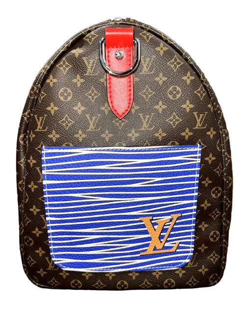 Louis Vuitton monogram canvas backpack with a blue and white striped fabric pocket on the front featuring a gold LV logo, and a red top handle.