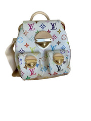 Louis Vuitton multicolor monogram bag with gold hardware in a box on a bed.