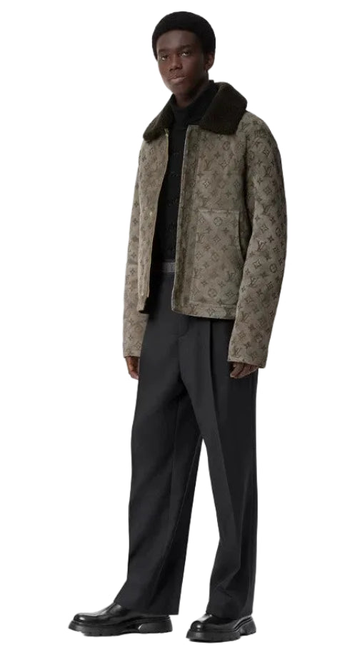 Man wearing a patterned coat and scarf with a plain background