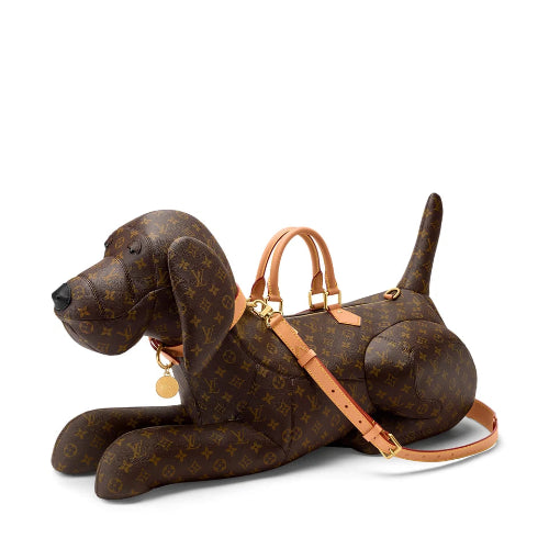 A brown plush dog-shaped bag with a tan strap and handle, photographed against a plain white background.