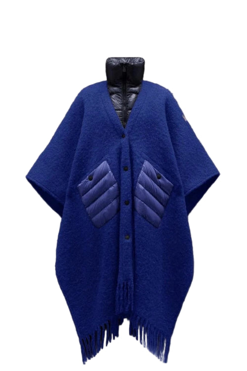 Blue poncho with quilted design on a black background