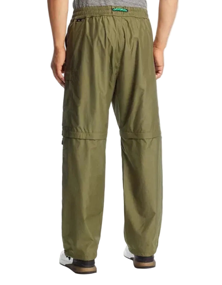 Green pants worn by a person on a plain background