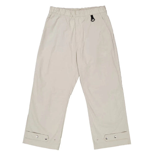 Beige pants with button details on a white background