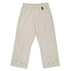 Beige pants with button details on a white background