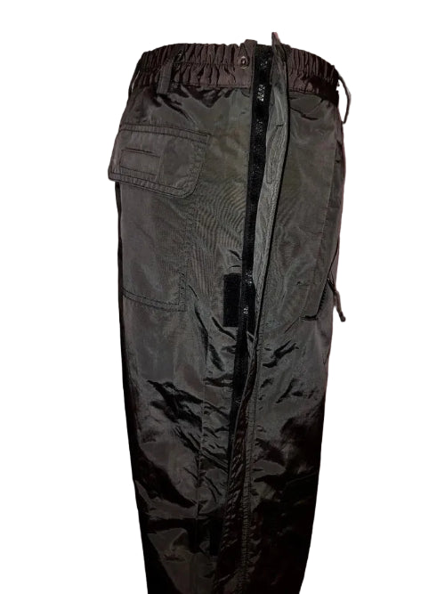 Dark green cargo pants on a hanger against a neutral wall.