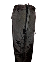 Dark green cargo pants on a hanger against a neutral wall.