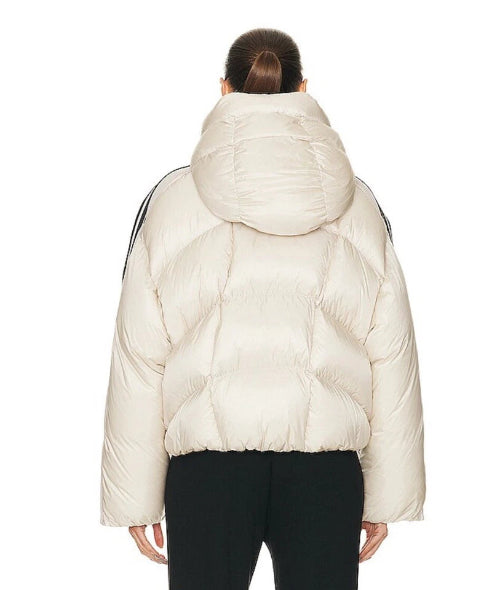 Person wearing a white puffer jacket on a white background