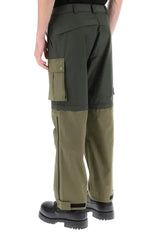 A close-up of a person wearing dark green cargo pants with multiple flap pockets and olive green work boots, shown against a plain light gray background.
