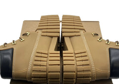 Tan leather shoes with gold accents on a white background