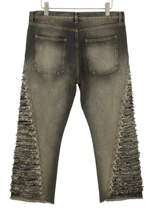 Distressed jeans with fringe details on a white background