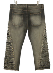 Distressed jeans with fringe details on a white background