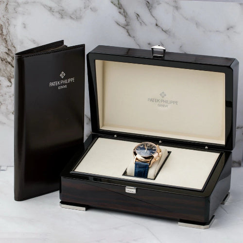 Patek Philippe watch in an open black display box on a marble background