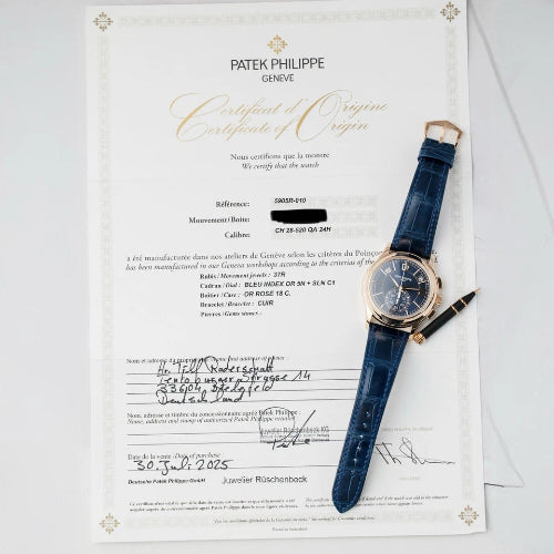 Patek Philippe watch with Certificate of Origin on a white background