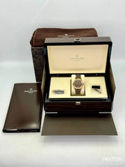 Patek Philippe watch in an open box with accessories on a white background