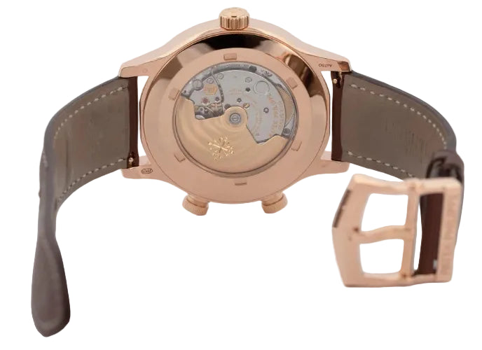 Rose gold watch with leather strap on a light gray background