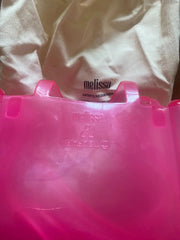Pink plastic bag with a white label on a white background