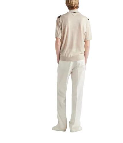 Person wearing a beige polo shirt and pants on a white background