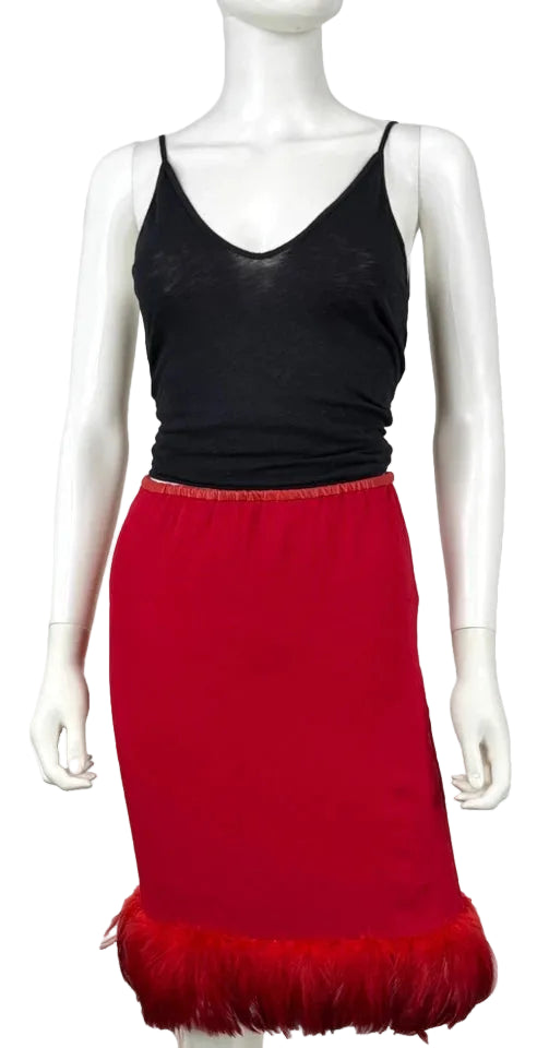A two-piece women's outfit displayed on a white mannequin, featuring a black spaghetti-strap camisole top and a red pencil skirt with a red feather-trimmed hem.