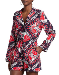 Woman wearing a colorful patterned dress with a blurred background