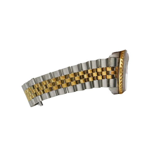 Two-tone watch bracelet held by a gloved hand on a white background