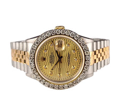 Luxury watch with gold and silver band on a white surface