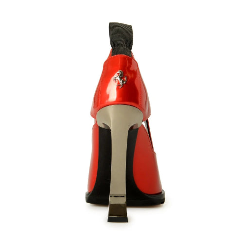 Red high-heeled shoe with a black sole on a white background