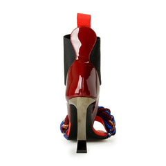 High-heeled shoe with red sole and multicolor strap on a white background