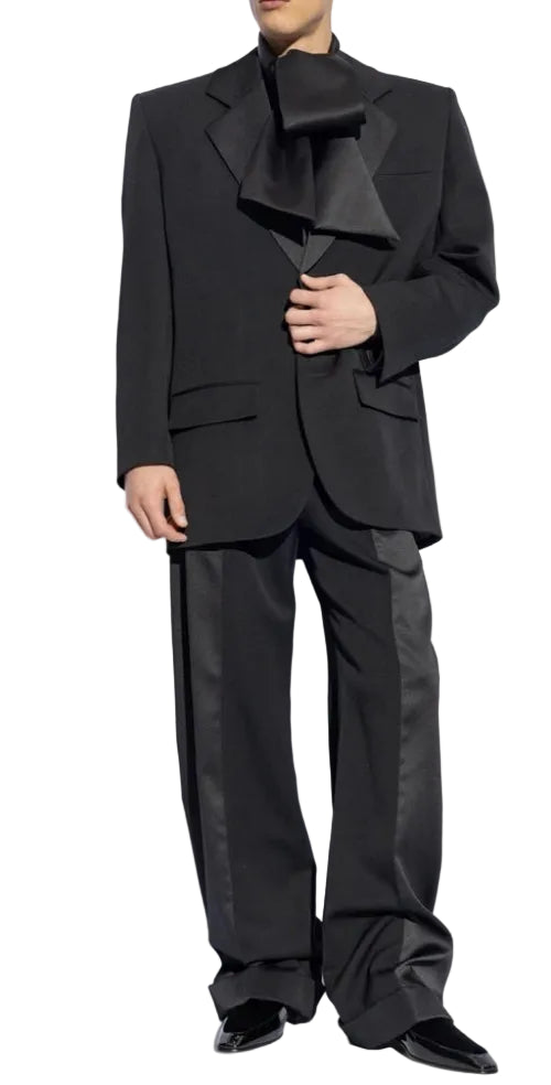 Black suit with a bow tie on a plain background