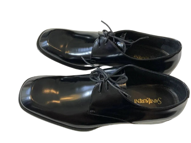 Pair of black leather shoes on a white background