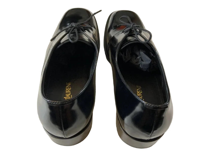 Pair of black shoes with 'Lauren' branding on a light background