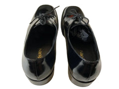 Pair of black shoes with 'Lauren' branding on a light background