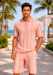 Man wearing a pink textured outfit standing in a tropical setting with palm trees and ocean.