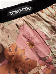 Close-up of Tom Ford men's boxer briefs featuring a pink and orange floral print with a black waistband and a visible TOM FORD label.