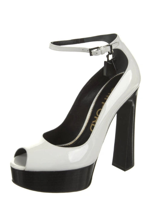 White high-heeled shoe with a black sole on a white background