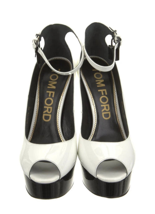 White high-heeled shoes with black soles on a white background