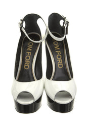 White high-heeled shoes with black soles on a white background