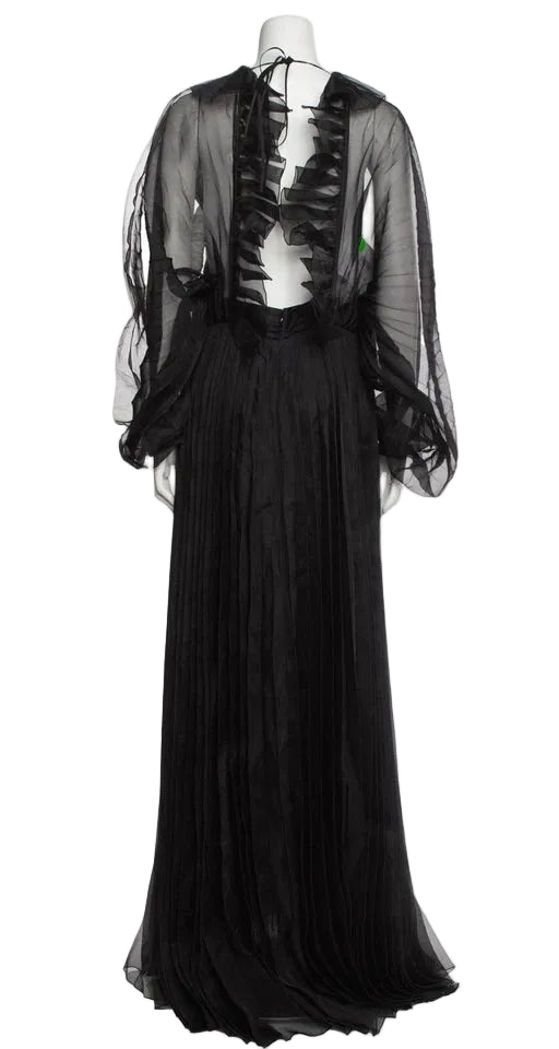 Black evening gown with sheer overlay on a mannequin against a neutral background
