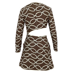 A long-sleeve mini dress with a brown and cream chain-link pattern, featuring a unique asymmetrical cutout at the waist on the back, shown against a plain white background.