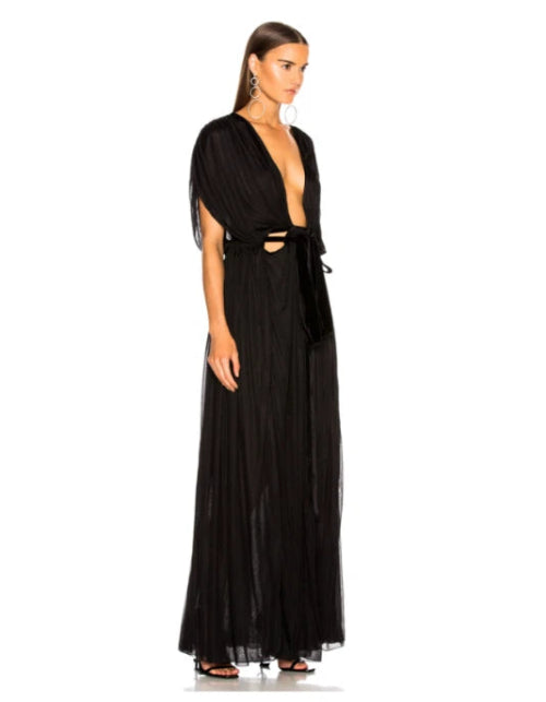 Woman wearing a black evening gown with cut-out design on a white background