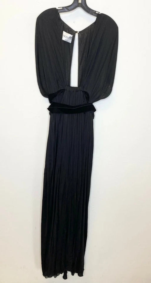 Black evening gown on a hanger against a white background