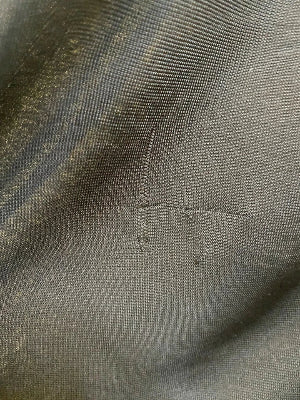 Close-up of textured gray fabric with visible stitching