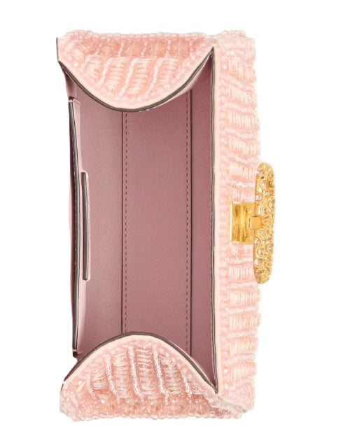 Pink textured clutch with gold clasp on a white background