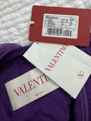 Valentino labels on a purple garment with a white quilted background